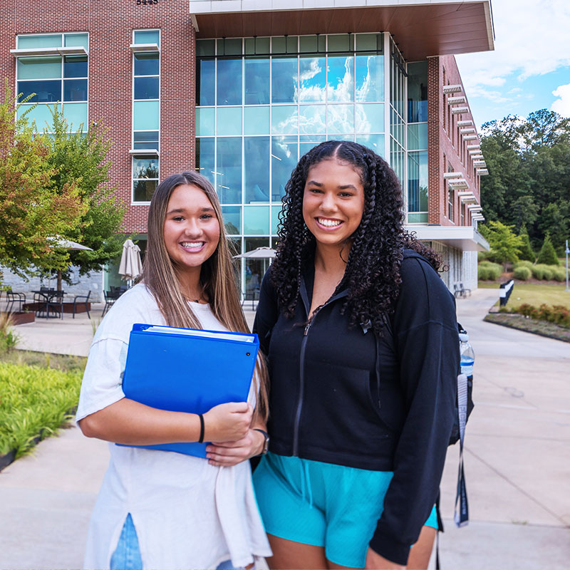 Young women on Cartersville campus, smiling.