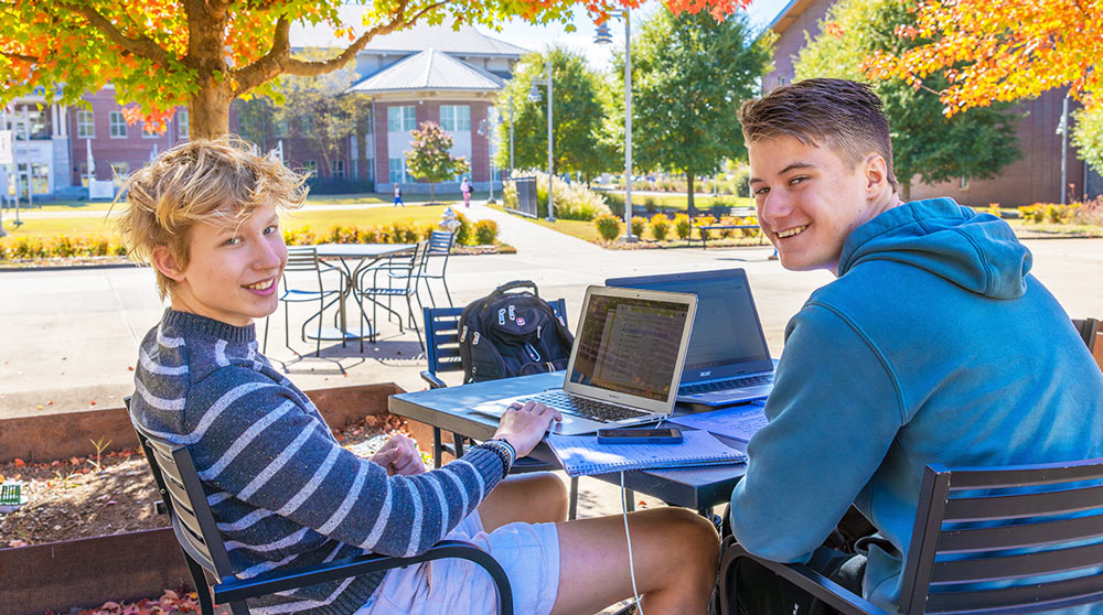 Young men on Cartersville campus, smiling.
