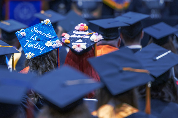 Graduation viewed from behind seated graduates
